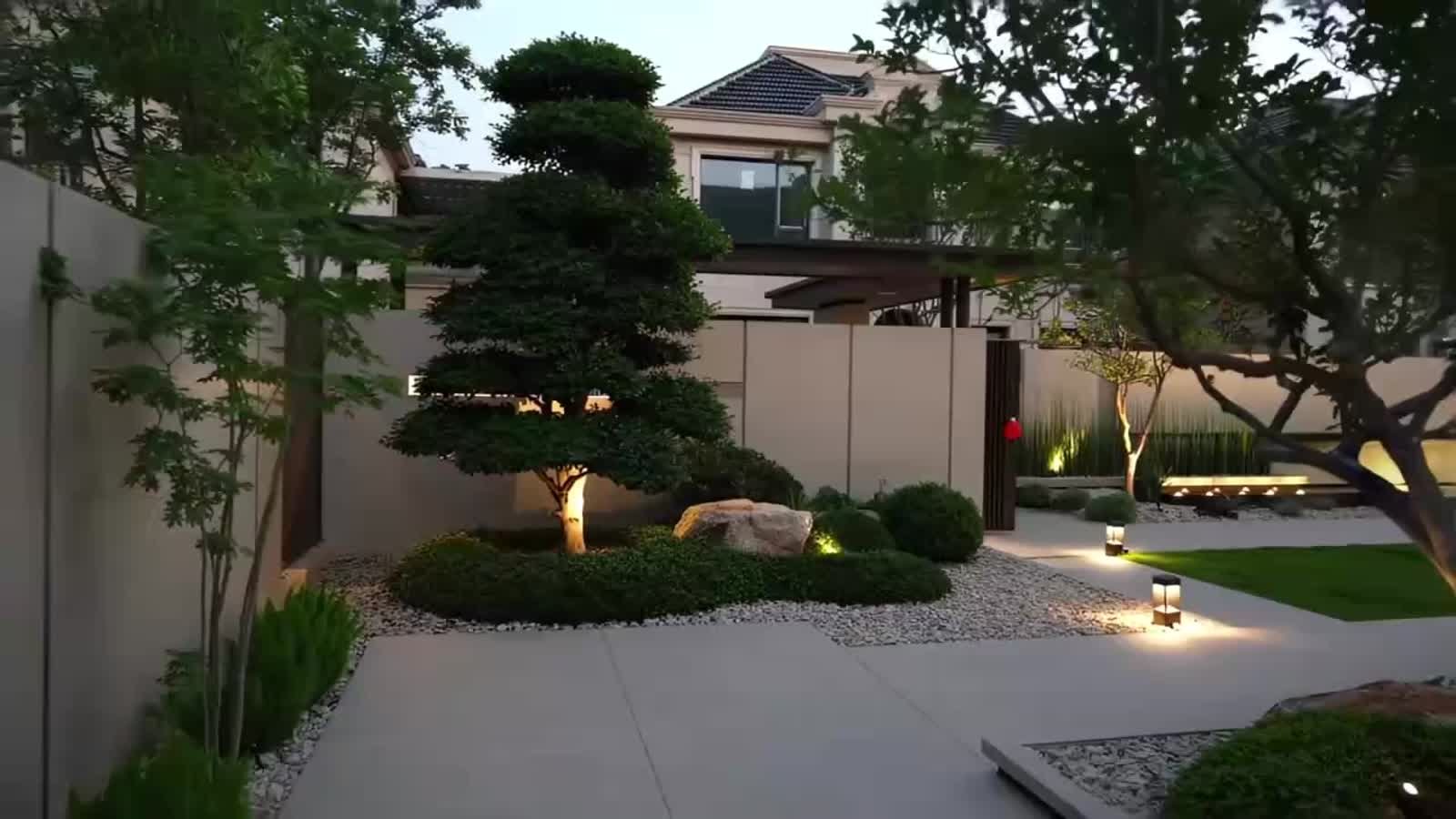 Minimal courtyard landscape with sculptural planting and lighting