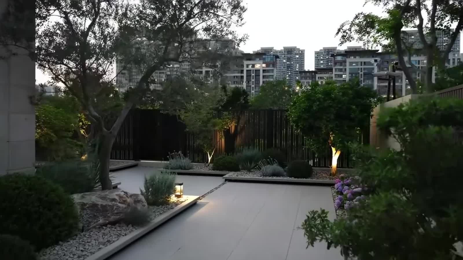 Garden path with layered planting and evening lighting